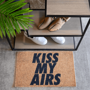 a shoe rack with a plant and a plant